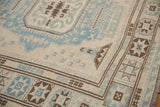 Hand-woven Afghani Soumac carpet border with geometric star patterns in powder blue, ivory, and brown.