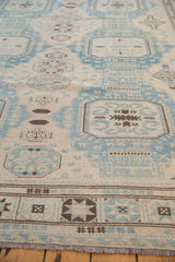 Afghani Soumac carpet border with geometric blue, ivory, and brown motifs and fringed edge.