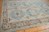 Geometric border in pale blue and brown with fringed edge on the Soumac carpet.