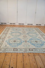 Angled view of Afghani Soumac design carpet, oversized powder blue medallions on ivory field.