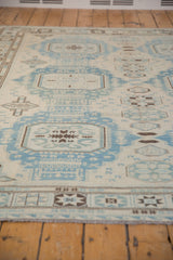 Geometric Afghani Soumac rug pattern in powder blue, ivory, and brown, with intact fringe.