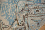 Detail of Afghani Soumac carpet showing pale blue, ivory, and dark brown geometric patterns.