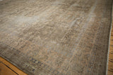 Distressed vintage Sparta carpet, showing faded dusty sage floral vinery and worn border.