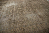 Muted dusty sage and beige floral blossom field of the distressed vintage Sparta carpet, worn texture.