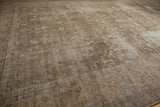 Vintage distressed Sparta carpet, faded floral vinery in dusty sage, olive, and beige.