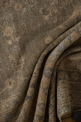 Distressed pile of vintage Sparta carpet, textured with faded floral motifs in dusty sage and ivory.