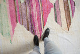 Layered abstract striations on a vintage Turkish Rag Rug in pink, green, and aubergine.