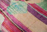 Abstract layered striations featuring pink, aubergine, teal, and ivory woven textures.