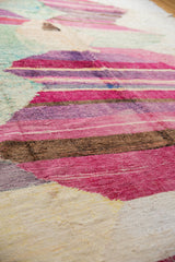 Textured hand woven rag rug with abstract pink, purple, brown, and ivory striations.