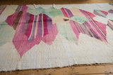 Ivory textured end of the hand woven Turkish rag rug with abstract pink striations.