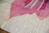 Abstract layered pink and ivory striations on a textured Turkish rag rug.