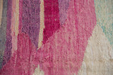Close-up of the hand woven Turkish rag rug texture, featuring pink, purple, and ivory striations.