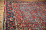 Vintage Mahal carpet's brick red field with intricate floral blossom and vine motifs.