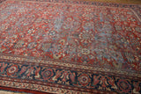 Vintage hand knotted Mahal carpet with brick red floral field and navy border.