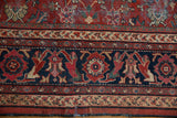 Mahal carpet's brick red floral field and navy blue border with stylized figures, showing wear.