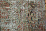 Distressed Mahal rug, faded blush, seafoam, ivory floral patterns, with visible foundation.