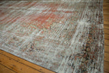 Distressed Mahal rug corner, showing faded terra cotta floral motifs and pale green details.