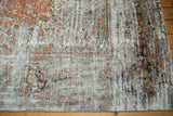 Corner of a vintage Distressed Mahal rug, showing muted floral motifs and soft patina.