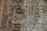 Distressed Mahal carpet close-up, showing worn pile, faded floral pattern, blush, and green.