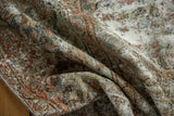 Folded vintage Distressed Mahal rug highlighting worn texture, blush, seafoam green, and ivory tones.