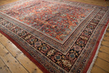 Vintage Mahal carpet corner, featuring brick red field, sprawling patterns, and multi-banded border.