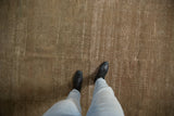 Distressed vintage Sivas carpet pile, showing subtle earthen hues and visible foundation texture.