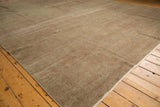 Distressed Sivas carpet texture with oxidized silver, earthen tones, and intact side selvage.