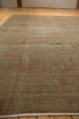 Intact light fringe and textured pile of a vintage distressed Sivas carpet.