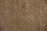 Textural detail of a vintage distressed Sivas carpet with abrashes and earthen silver tones.