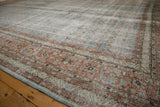 Distressed texture and pale blue, terra cotta Herati patterns on a vintage Tabriz rug.