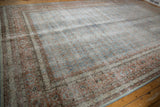 Distressed vintage Tabriz carpet with faded Herati design in pale blue and blush.