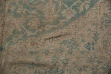 Distressed Oushak rug with ocean green curvilinear pattern and worn ivory knot heads.