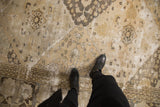 Distressed vintage Khorassan carpet texture, showing floral diamond panels and border.