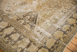 Distressed Khorassan rug corner, showing floral panels and faded palmette border in soft tones.