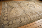 Distressed vintage Khorassan rug corner, showing oversize palmette border and mostly even wear.