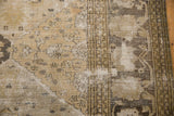 Distressed vintage Khorassan rug with floral diamond panels, detailed buds, and palmette border.