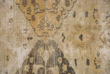 Distressed texture on vintage Khorassan rug, with beige, gold, and ivory floral details and foundation visible.