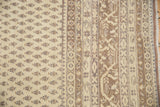 Distressed Sivas carpet: ivory field, diminutive boteh, Serbend border, intact selvage.