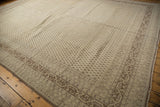 Detail of vintage distressed Sivas rug, showing evenly worn ivory boteh field and Serbend border.
