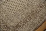 Distressed ivory and beige Sivas carpet corner, showing boteh field and Serbend vine border.