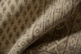 Distressed Sivas carpet detail, showing textural pile and diminutive boteh in ivory and dark beige.