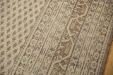 Close detail of distressed Sivas carpet: worn ivory and dark beige boteh and vine motifs.