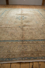 Distressed Tabriz carpet showing worn pile texture, faint foundation, and sky blue border detail.