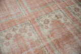 Distressed vintage Oushak carpet, worn blush pile with ivory paneled mini-prayer motifs.