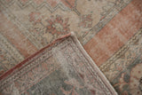 Worn pile texture and hand-knotted foundation of the vintage distressed Oushak rug.