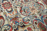Dramatic oversized madder red palmettes and indigo vinery on ivory Mahal carpet.