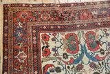 Mahal carpet corner: ivory field with red lotus, blue vinery, and madder root red border.
