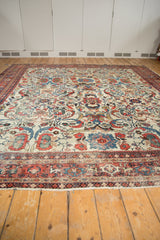 Vintage Mahal carpet's classic madder red Samovar border, ivory field with lotus flowers, tattered fringe.