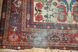 Mahal carpet's worn lower corner: low pile, exposed foundation, red-blue borders, tattered fringe.