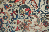 Vintage Mahal carpet detail: hand-knotted ivory field, madder root red palmettes, indigo blue vines.